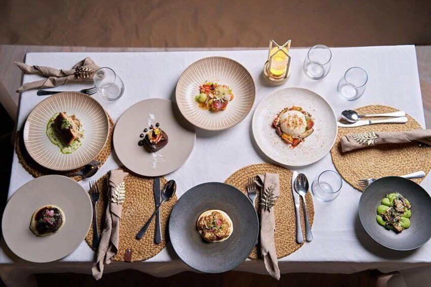 A table set with various dishes, cutlery, and glasses. 5