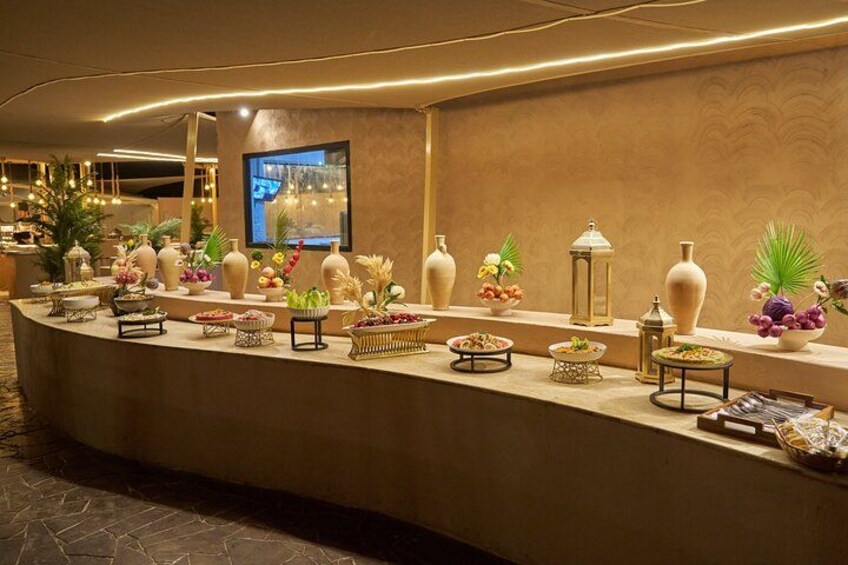 A reception area with a curved counter, decorative vases, and a television screen. 4