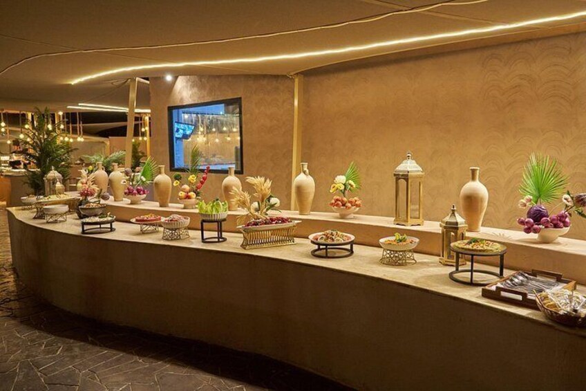 A reception area with a curved counter, decorative vases, and a television screen. 4