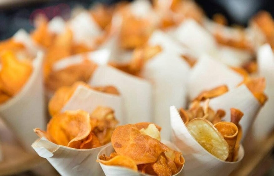 A tray of crispy snacks in paper cups. 3