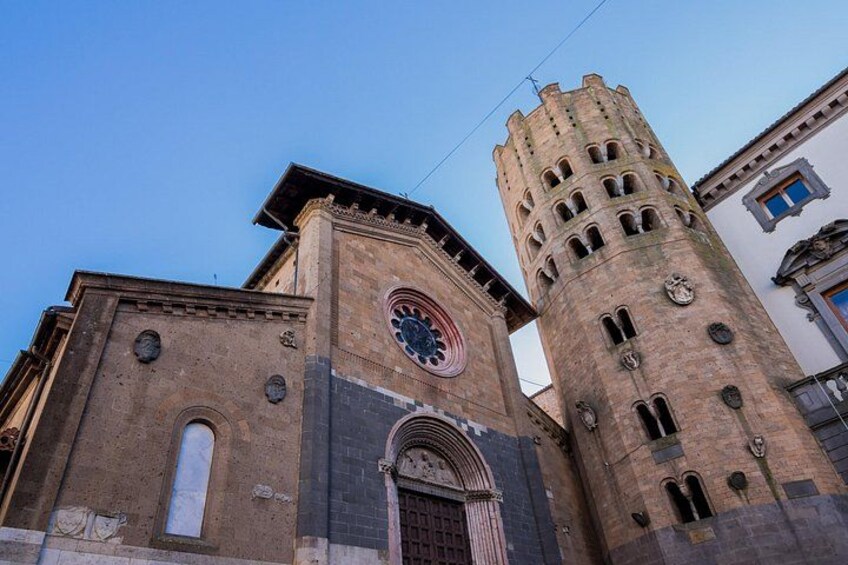 A historic church with a prominent clock tower and a large arched entrance. 3