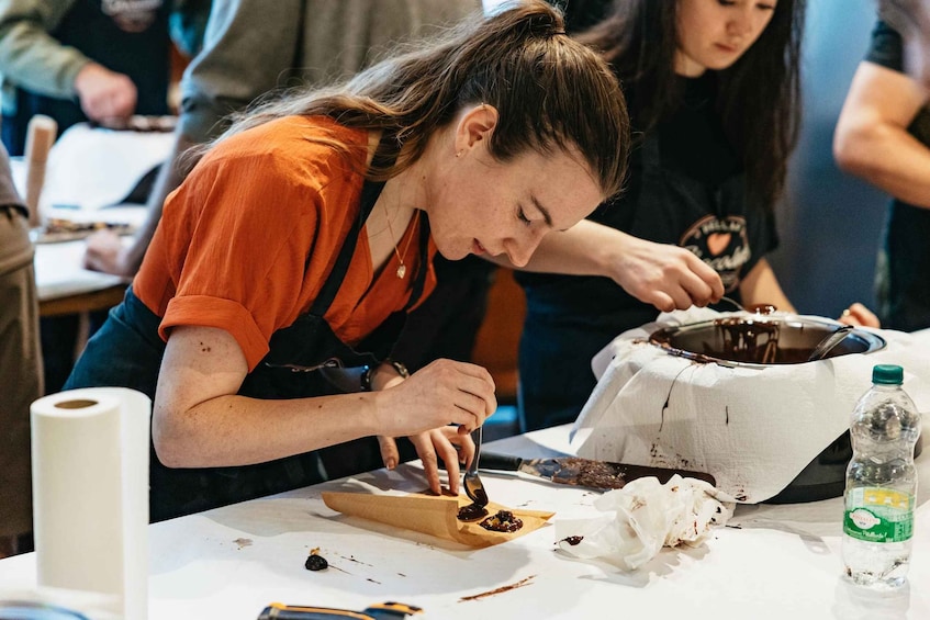 A person cutting food with a knife on a table. 2
