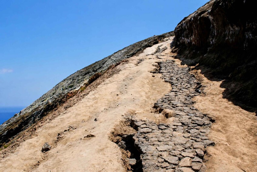 A rocky mountain trail with a clear sky. 2