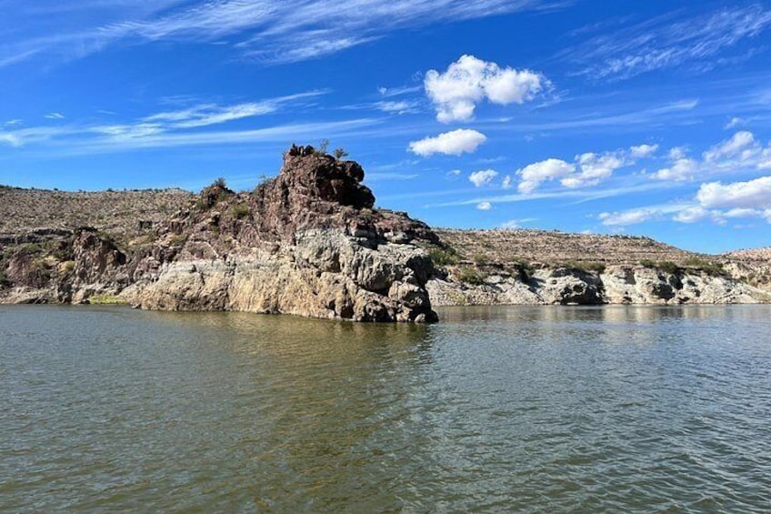 A rocky outcrop surrounded by water. 2
