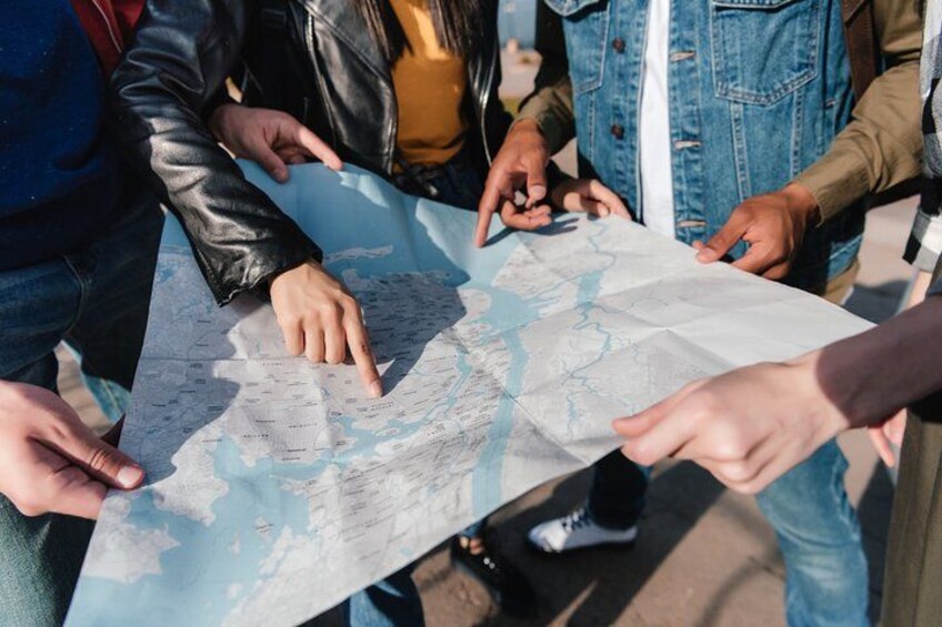 A group of people examining a large map. 2