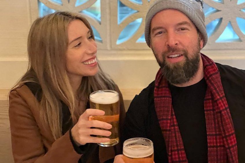 Dos personas sosteniendo vasos de cerveza. 2