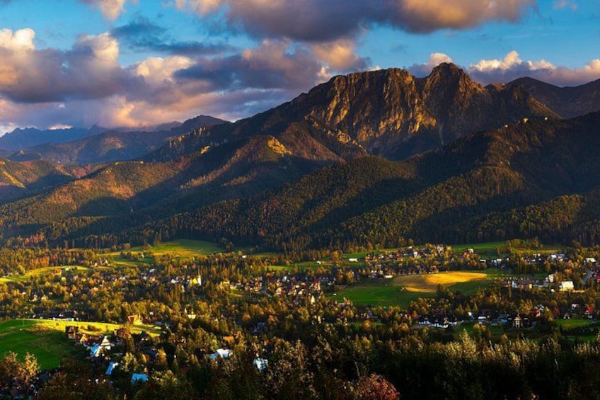 A mountainous landscape with a village nestled in the valley. 4