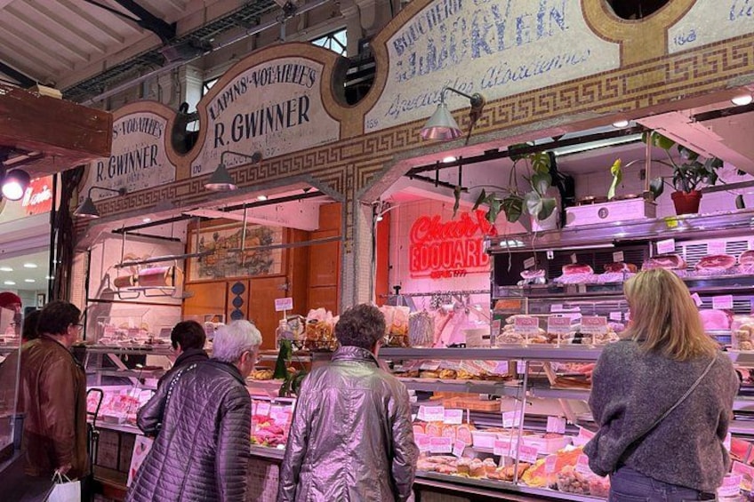A bakery with a sign that reads 'R.GWINNER' and displays various baked goods. 2