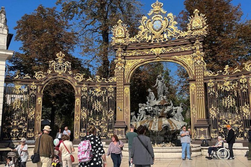 An ornate golden gate with statues and intricate designs. 4