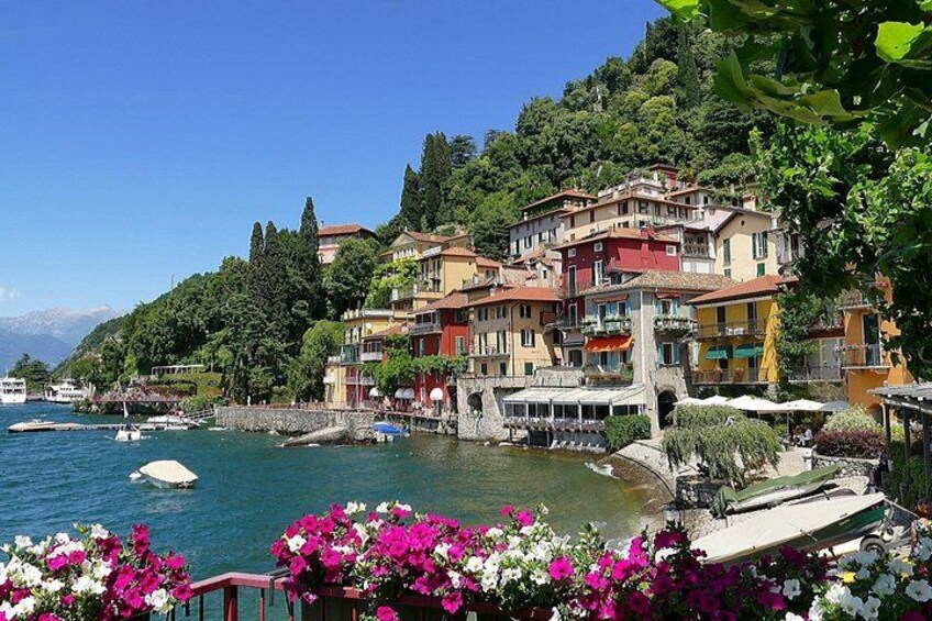 A coastal town with colorful buildings, boats, and lush greenery. 1