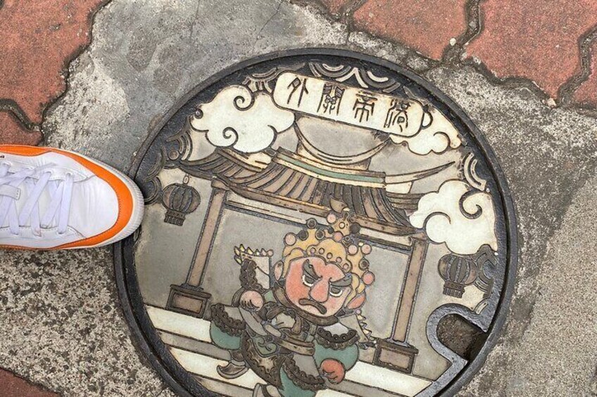 Isn't it cute? a manhole cover with illustration related to culture of Tainan.