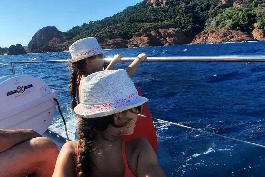 A boat on the water with rocky cliffs in the background. 4
