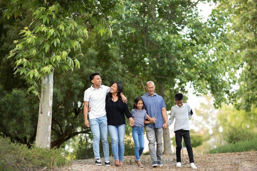 A family walking on a path surrounded by trees. 5