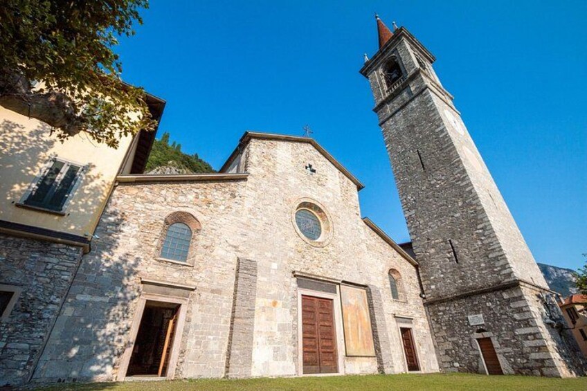 A stone church with a bell tower and arched windows. 3
