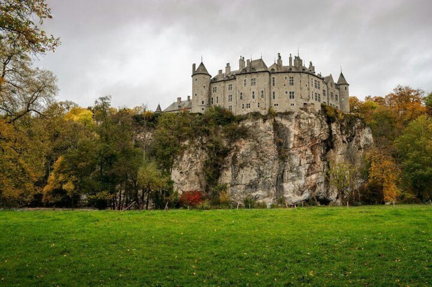 A castle on a cliff with a grassy foreground. 4