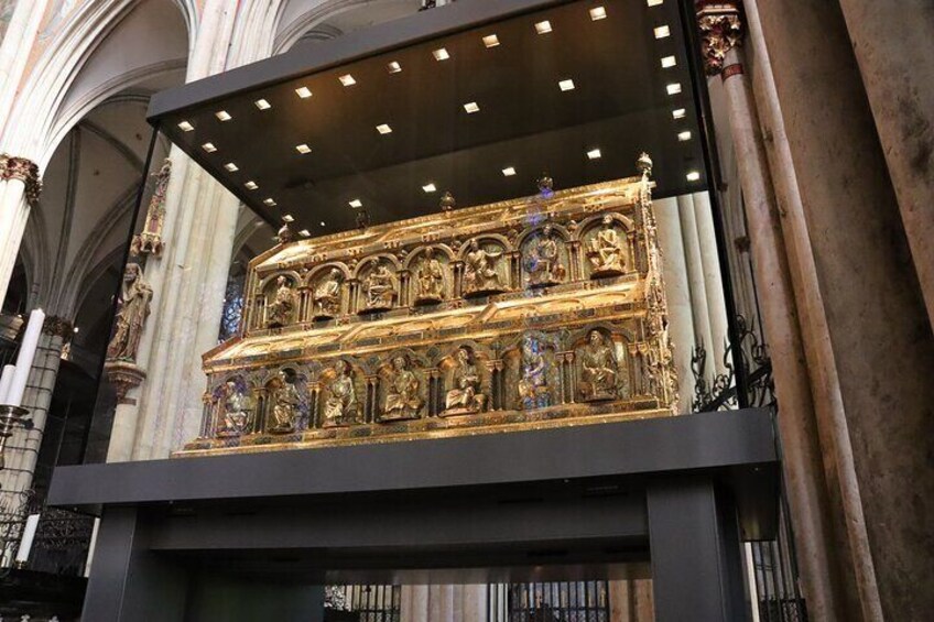 A golden religious artifact displayed in a cathedral. 3