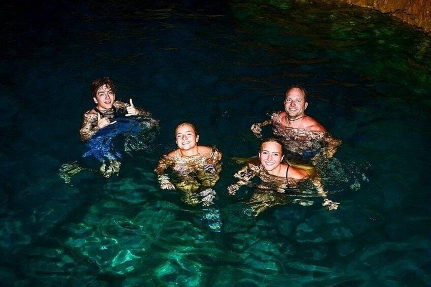 Four people in a swimming pool. 3