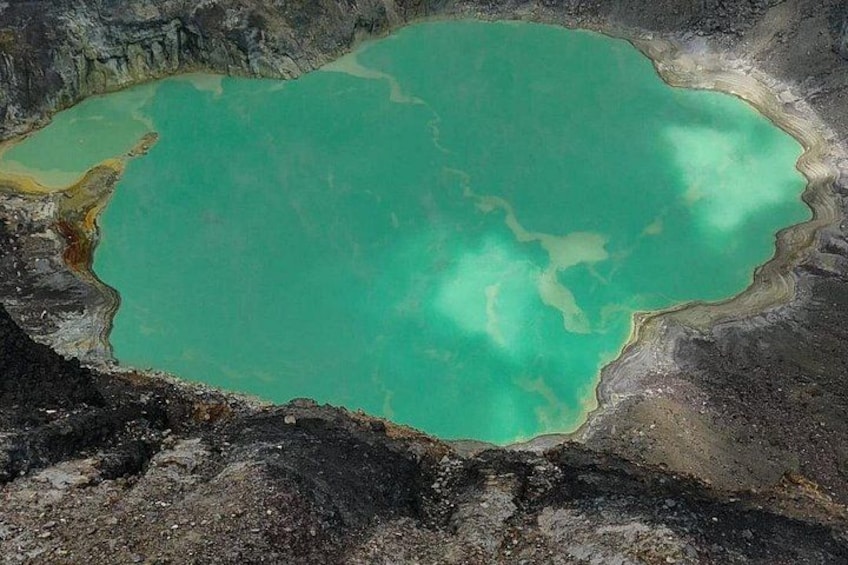 A turquoise lake surrounded by rocky terrain. 4
