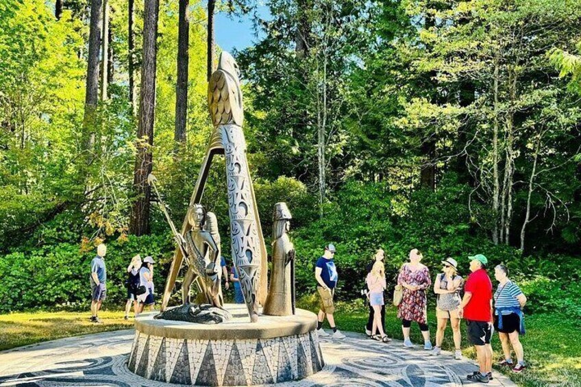 A sculpture in a park with people around it. 5