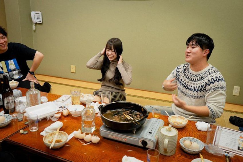 A dining table with food, a frying pan, and a weighing scale. 2