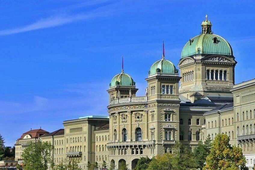 A large, ornate building with multiple domes and arched windows. 5