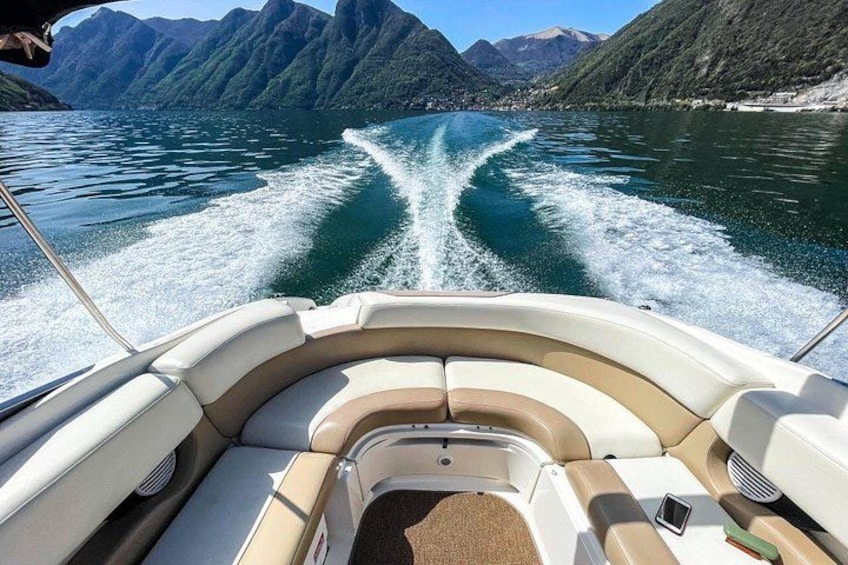 A boat on a lake with mountains in the background. 5