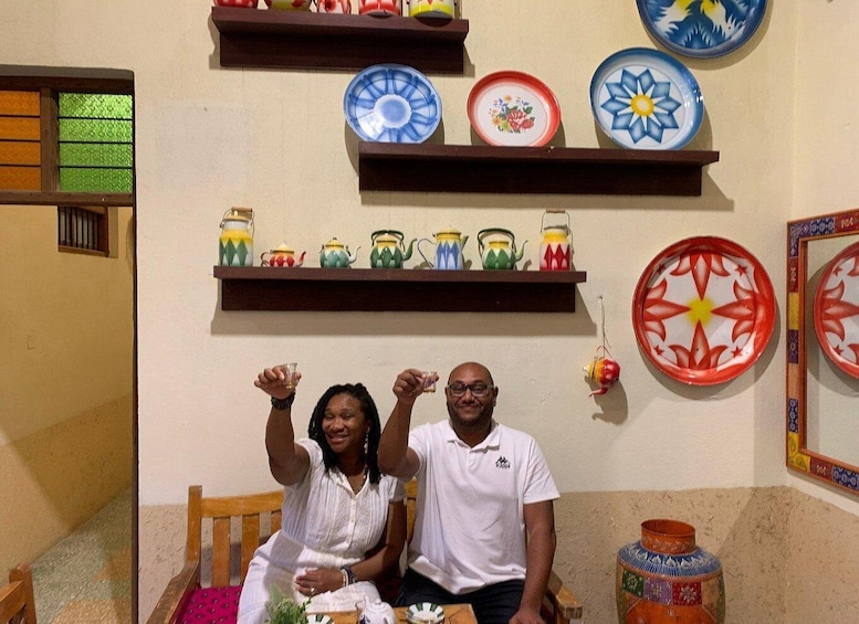A room with shelves holding colorful plates and teapots. 3