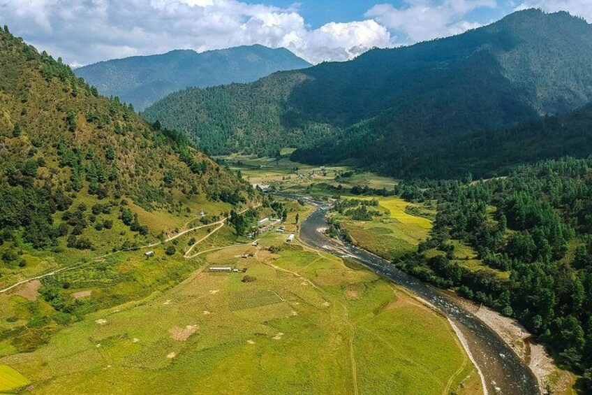 A river winding through a valley with mountains in the background. 3