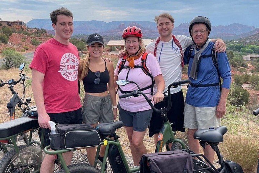 A group of people with bicycles in a desert landscape. 5