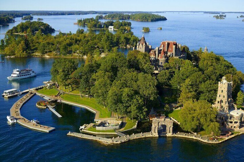 An island with a castle, surrounded by water and greenery. 1