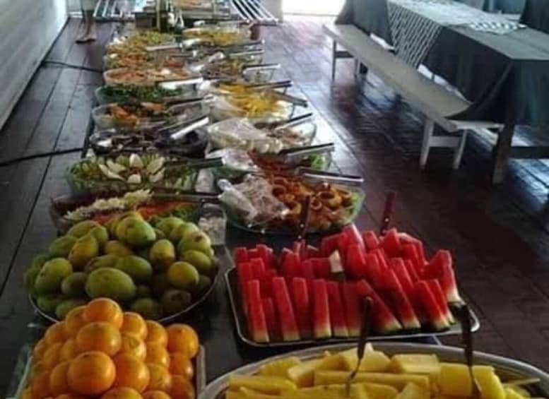 A buffet table with various fruits and vegetables. 1