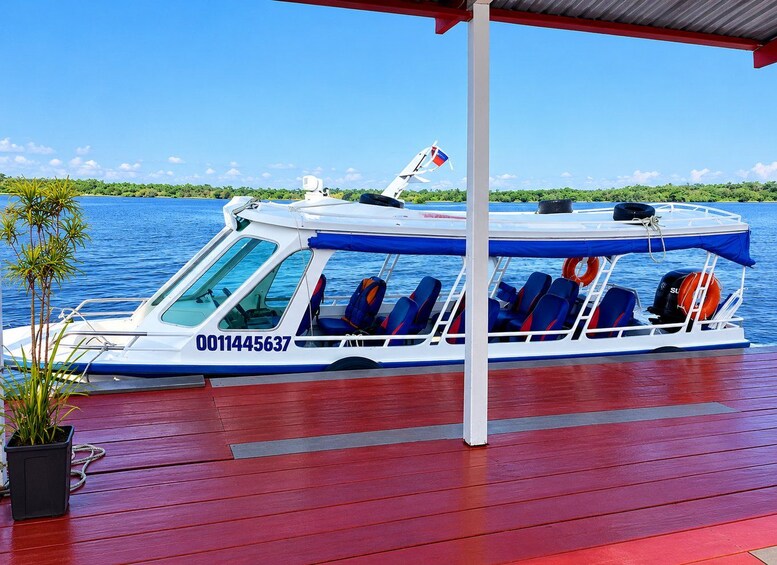 A boat with blue and white colors, a registration number, and a flag on top. 4