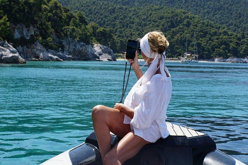 A person on a boat taking a photo with a camera. 3