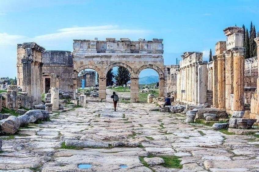 Ancient ruins with stone columns and an archway. 3