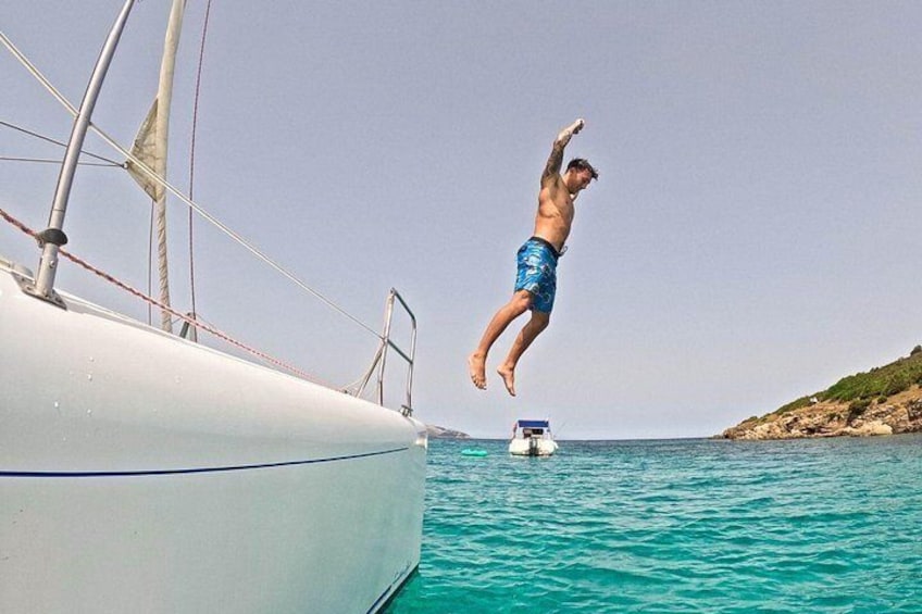A person jumping from a boat into the water. 4