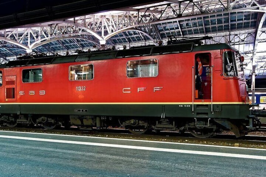 A red train with the number 11332 at a station. 5