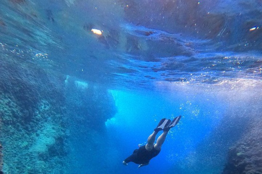 A diver underwater in a clear blue environment. 2