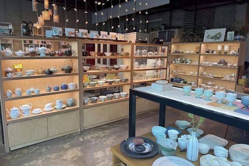 A store with shelves of ceramic tea sets and teapots. 2