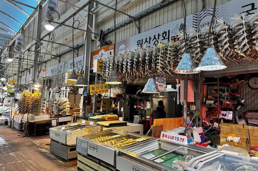 A market with seafood displays, including fish and other seafood items. 4