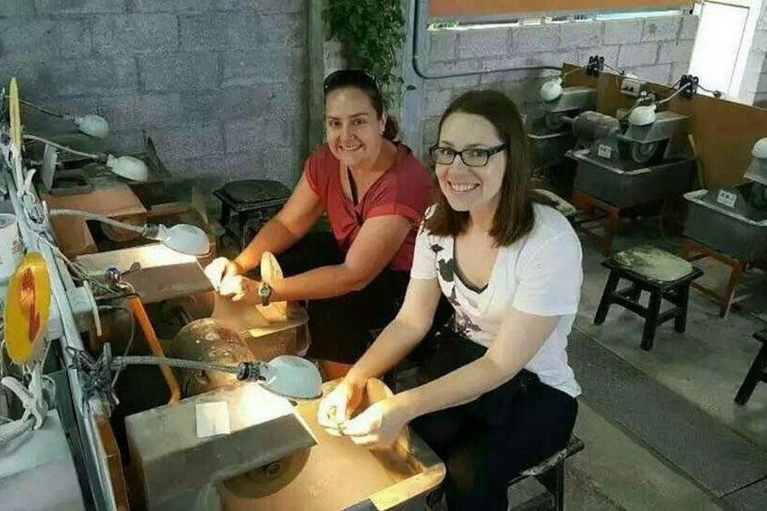 Two people working with pottery wheels in a workshop. 2