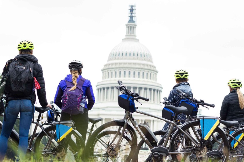 A group of cyclists with bicycles in front of the United States Capitol building. 2