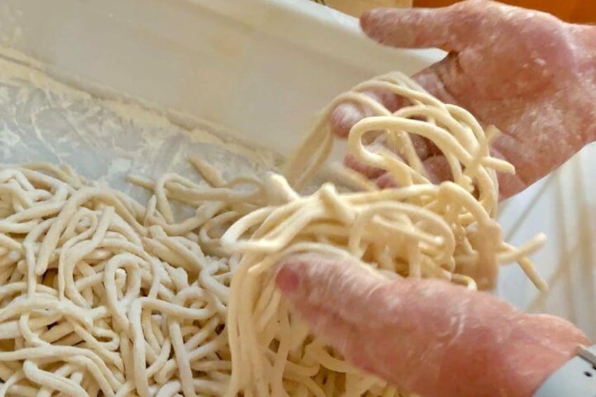 Hands holding uncooked pasta. 3
