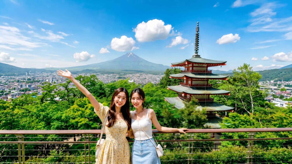 Two people posing with a pagoda and a mountain in the background. 5