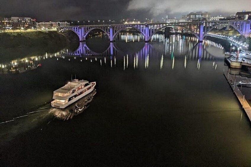 A river with a bridge and a boat. 2