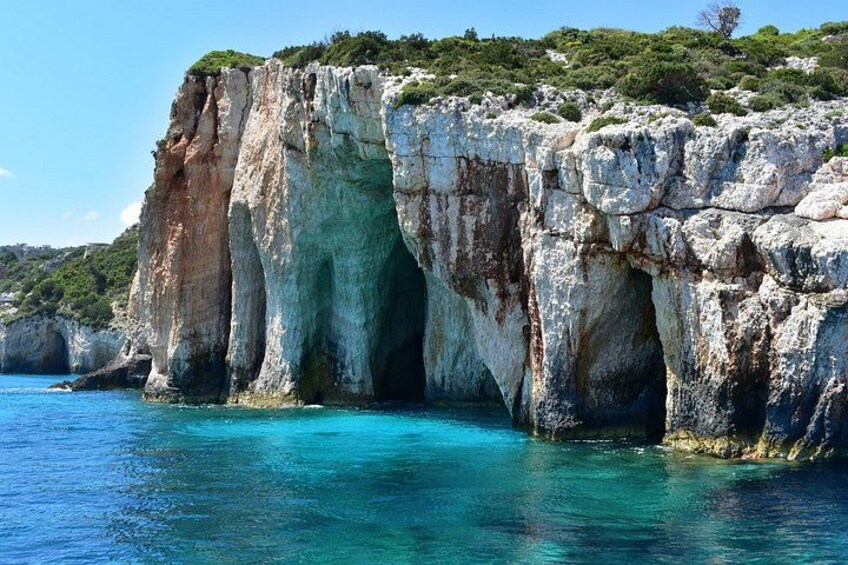 A coastal cliff with a natural arch formation. 4