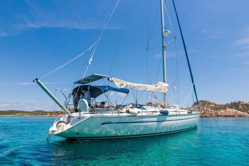 A sailboat on calm turquoise waters with a clear sky. 5