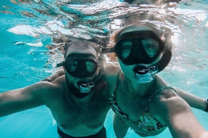 Two people underwater in a swimming pool. 1