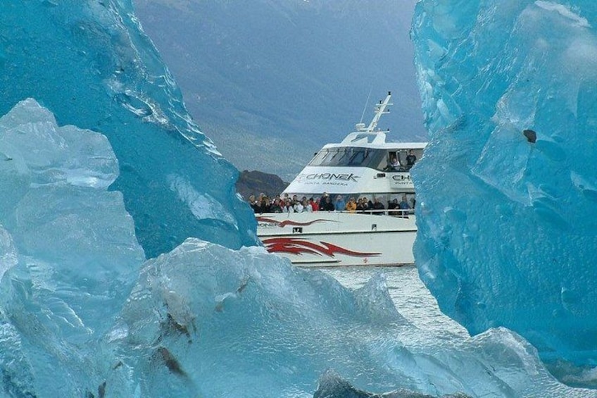 A boat navigating through a large ice formation. 1