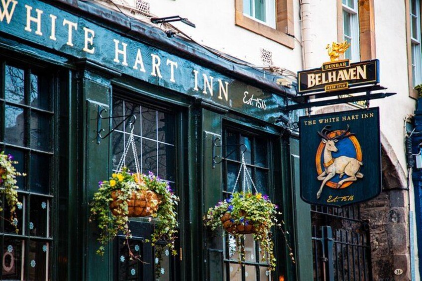 La façade de l’auberge White Hart, ornée de jardinières suspendues et d’une enseigne indiquant la brasserie Belhaven. 2