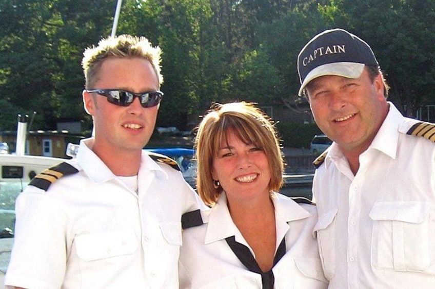 Three people in white uniforms with one wearing a captain's hat. 4